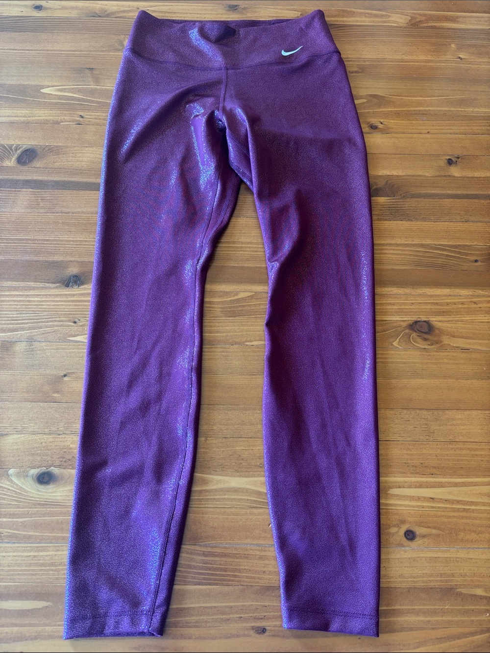 Nike burgundy shimmery Leggings, size women’s small. Never worn.